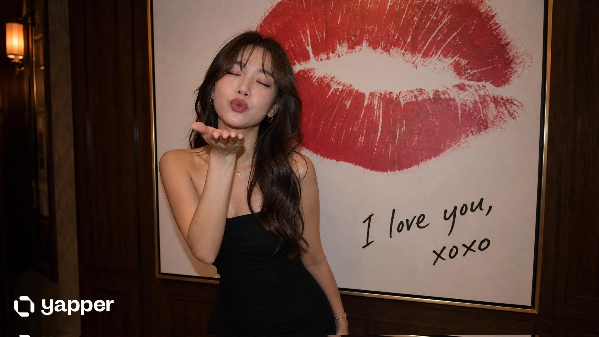 East Asian Woman Blowing Kiss in Elegant Dress